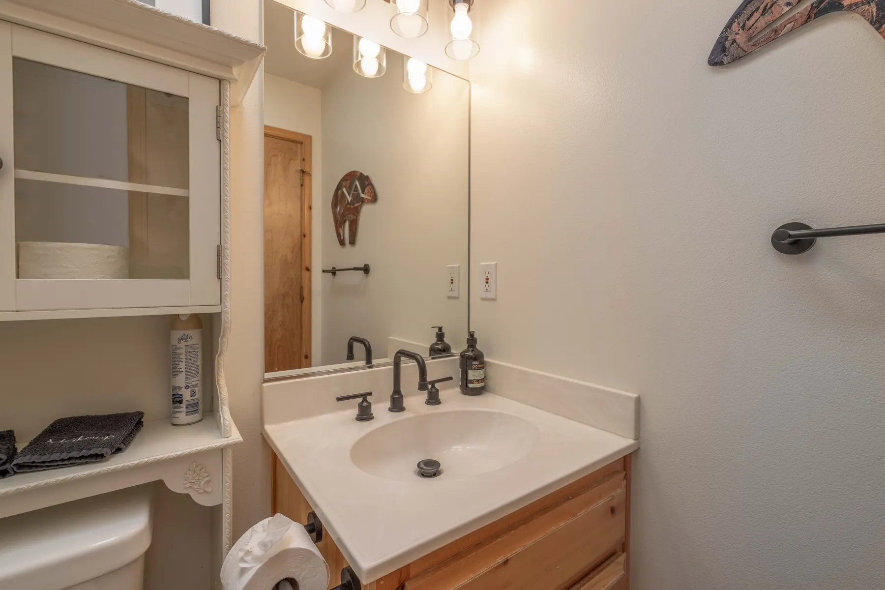 Bathroom Two at Pine Grove Cabin with vanity sink, cabinet storage, and mountain decor