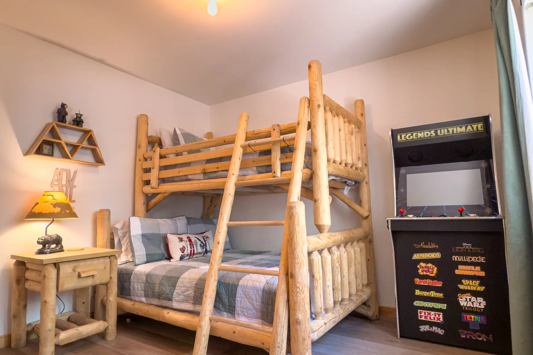 Bedroom Three at Pine Grove Cabin with the Legends Ultimate arcade cabinet loaded with classic games next to the log bunk bed