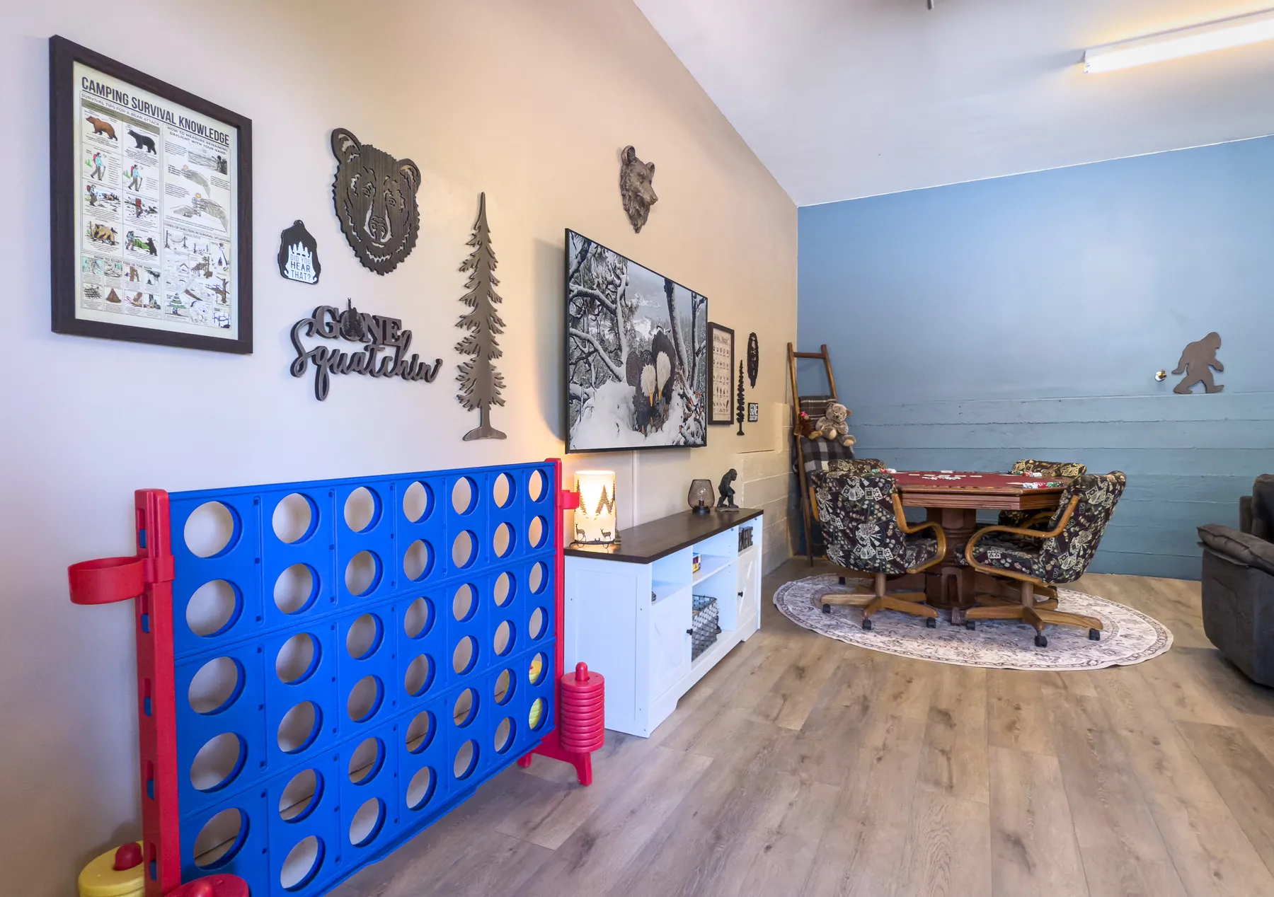 Jumbo Connect Four and Bigfoot-themed lounge area in the Sasquatch Den at Pine Grove Cabin